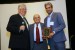 Professor T. Grandon Gill, Chair of the Award Ceremony, and Dr. Nagib Callaos, General Chair, giving Dr. Kostas Demestichas, a plaque "In Appreciation for A Great Keynote Address at a Plenary Session."